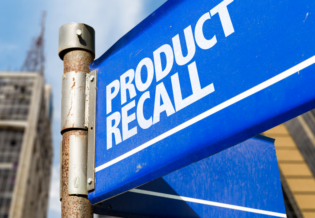 blue signage with product recall printed on it