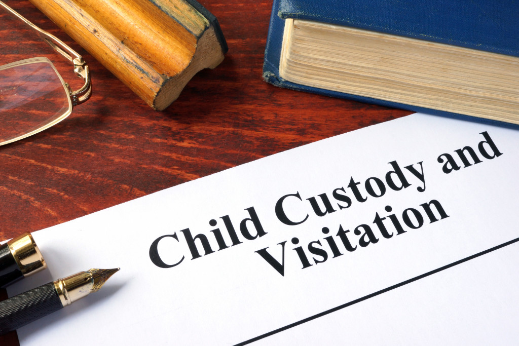 child custody visitation written on paper beside a book
